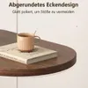 Dunkelbrauner Holztisch mit abgerundeter Ecke, mit einer beigen Tasse mit Löffel und einem Buch Voir les images du produit