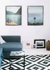 A living room scene with a sofa, coffee table, rug, and framed pictures on the wall. Produktbild-Vorschau
