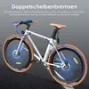 A white electric bicycle with blue accents, shown on a dark gray asphalt surface, with marketing text overlay. Produktbild-Vorschau