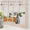 A mirror with a wooden frame, reflecting a room with furniture and flowers in vases. Náhľad obrázku produktu