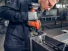 A person is using a cordless reciprocating saw to cut metal. Produktbild-Vorschau
