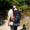 A person is hiking on a trail with a backpack and trekking poles. Anteprima dell’immagine prodotto