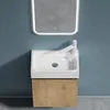 A modern bathroom vanity with a sink and faucet, mounted on a blue wall. Produktbild-Vorschau