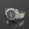 A silver Casio Edifice men's watch with a black dial and gold accents is shown on a reflective black surface. Produktbild-Vorschau