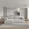 A modern living room with a light gray sectional sofa in front of a sleek kitchen. Produktbild-Vorschau