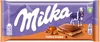 A Milka Toffee Creme chocolate bar packaging with images of mountains, a cow, and a cross-section of the chocolate bar. Podgląd zdjęcia produktu