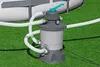 A pool filter pump system is shown on a green lawn next to an above-ground swimming pool. Produktbild-Vorschau