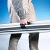A person is holding a long, silver, cylindrical object with black handles. Náhled obrázku produktu
