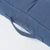 A close-up view of a dark blue cushion with a fabric handle. Náhled obrázku produktu