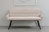 A beige upholstered bench with black legs is shown against a light gray wall with a framed picture above it. Produktbild-Vorschau