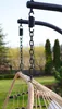Close-up of the suspension mechanism of a hanging chair, showing chains and springs attached to a stand. Podgląd zdjęcia produktu
