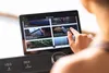 A person is using a tablet on a treadmill. Produktbild-Vorschau