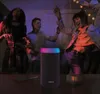 People dancing at a party with a speaker. Voir les images du produit