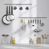 A kitchen scene with cooking utensils, scales, and containers arranged on a countertop. Produktbild-Vorschau