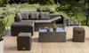 A patio furniture set is arranged on a wooden deck in a garden setting. Náhled obrázku produktu