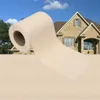 A roll of cream-colored material is unfurling in front of a house. Náhľad obrázku produktu