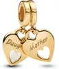 A close-up studio shot of two gold heart-shaped charms dangling from a bracelet clasp. Produktbild-Vorschau