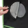 A close-up of a hand opening a vent on a black grow tent with green trim. Náhled obrázku produktu