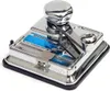 A close-up studio shot of a chrome cigarette rolling machine. Anteprima dell’immagine prodotto