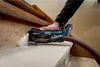 A person is using a Metabo multitool to sand a wooden staircase. Náhľad obrázku produktu