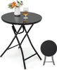 A black folding garden table with a glass top, a vase of flowers, and a glass of drink on it. A smaller folded table is shown in the lower right corner. Produktbild-Vorschau