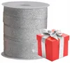 A roll of glitter ribbon and a red gift box with silver ribbon. Produktbild-Vorschau