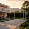 A modern house with a white carport in the driveway during sunset. Produktbild-Vorschau