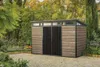 A garden shed is shown in a backyard setting with trees and plants surrounding it. Produktbild-Vorschau