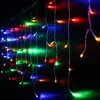 A close-up of colorful LED string lights hanging against a dark background. Produktbild-Vorschau