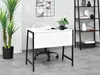 A modern home office setup with a white desk and black frame, a rolling chair, a tall plant, and a black shelving unit. Anteprima dell’immagine prodotto