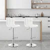 Two white bar stools in a modern kitchen setting. Produktbild-Vorschau