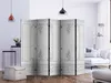A room divider is set up in a living room with a sofa and floor lamp in the background. Produktbild-Vorschau