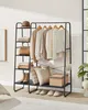 A stylish garment rack filled with clothing and accessories, placed in a room with a large window. Náhled obrázku produktu