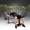 A man is using a black weight bench with weights attached to the side. The background is dark gray with bright yellow text overlay. Produktbild-Vorschau