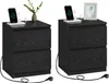 Two black bedside tables with charging stations and phones are shown in a studio setting. Náhled obrázku produktu