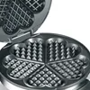 A close-up view of an open waffle maker with heart-shaped molds. Náhľad obrázku produktu