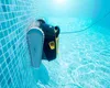 A pool cleaning robot is shown underwater, climbing a tiled wall of a swimming pool. Produktbild-Vorschau