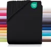 A black jersey fitted sheet is shown folded, with a stack of other colored sheets visible in the background. Produktbild-Vorschau