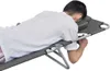 A person lying face down on a reclining chair with a headrest. Podgląd zdjęcia produktu