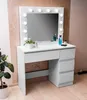 A white vanity table with a mirror and lights, decorated with plants and toiletries. Produktbild-Vorschau