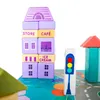 A close-up of wooden toy blocks arranged to form buildings and a traffic light on a play mat. Anteprima dell’immagine prodotto