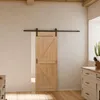 Moderne Holzschiebetür im Scheunentor-Look mit schwarzer Laufschiene im Design Eiche. Produktbild-Vorschau