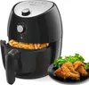 A black air fryer with a basket full of french fries, and a plate of fried chicken and lettuce next to it. Produktbild-Vorschau