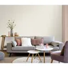 A living room scene with a sofa, coffee tables, and a chair. Náhled obrázku produktu