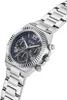 A close-up, angled view of a silver Guess watch with a blue textured dial and multiple sub-dials. Voir les images du produit