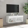 A white TV stand with a TV mounted above it, decorated with a plant and vases. Anteprima dell’immagine prodotto