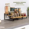 A 3-tier bamboo and black metal kitchen shelf filled with various spice jars and bottles, displayed on a countertop. Voir les images du produit