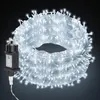 A coiled string of white LED lights with a black power adapter. Produktbild-Vorschau