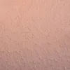 A close-up texture shot of a pink surface with gold glitter flecks. Produktbild-Vorschau