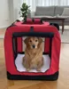A golden retriever dog is sitting inside a red dog crate in a living room. Produktbild-Vorschau